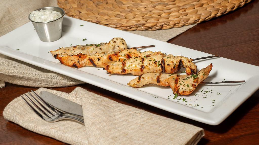Chicken Skewers · Chicken skewers marinated and grilled served with a side of housemade tzatziki.