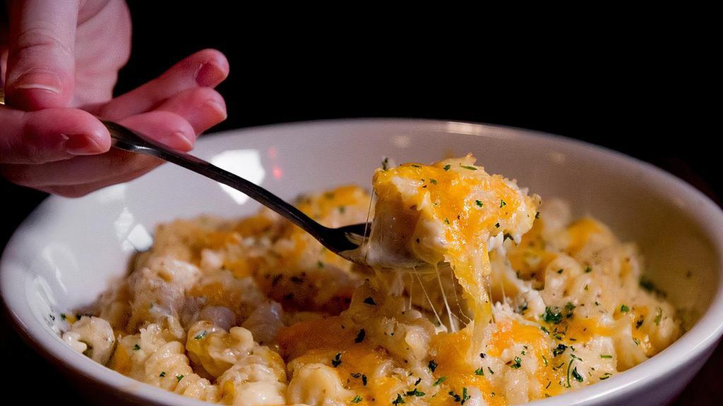 Fiery Mac & Cheese · Creamy mac and cheese made with our fiery feta dip with sausage and corn topped with crispy breadcrumbs.