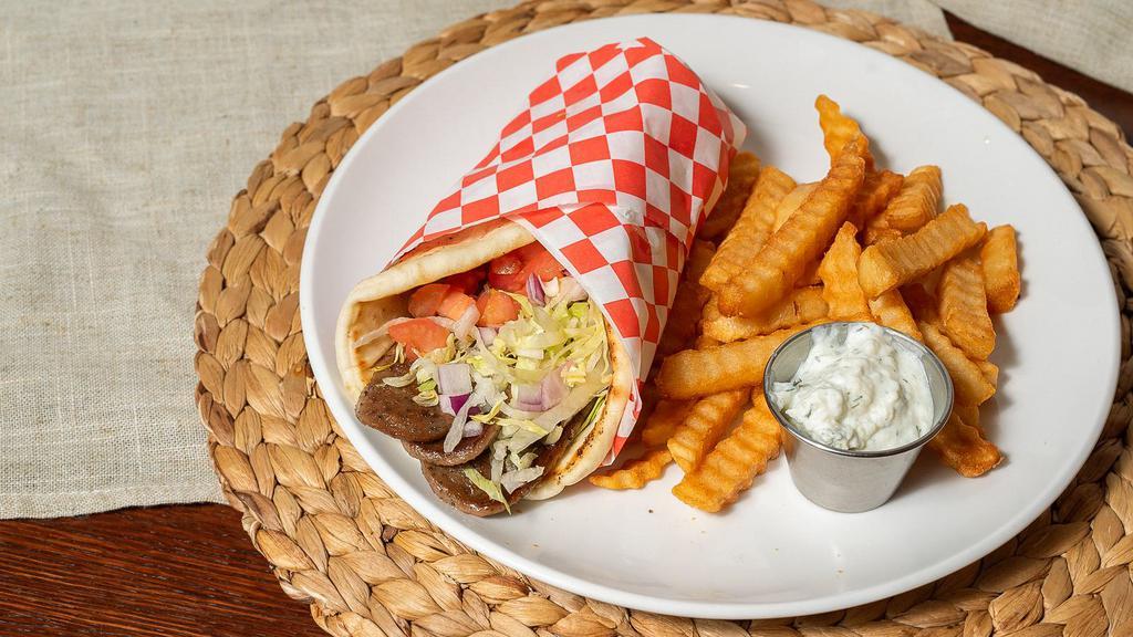 Gyro · Warm pita bread stuffed with gyro meat, lettuce, tomato, and red onion. Served with a side of housemade tzatziki.