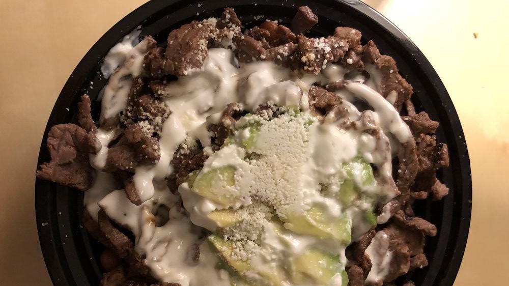 Steak Protein Bowls · With pinto beans, rice, sour cream, avocado & cotija cheese with grilled steak.