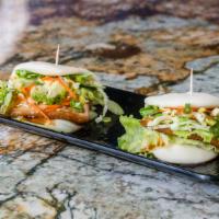 Chashu Buns (2Pc) · 2 pieces. Tender pork belly served in a Japanese bun with lettuce and cucumber slices.