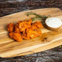 Buffalo Wings · Our famous wings fried until perfectly golden and crisp. Tossed in buffalo sauce, served wit...