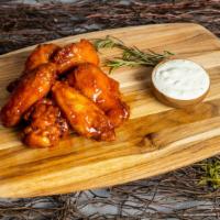 Honey Hot Wings · Our famous wings fried until perfectly golden. Tossed in garlic sauce, served with your choi...
