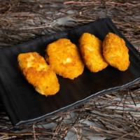 Jalapeno Poppers · Juicy jalapeno poppers breaded and filled with cheese and fried to golden perfection.