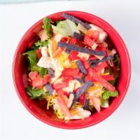Southwest Chicken Salad · Romaine lettuce topped with tomato, onion, tri-colored tortilla strips with Jack Cheddar che...