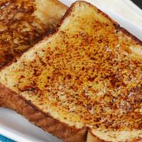French Toast · Two slices of Texas toast cooked golden brown with warm butter and maple syrup, your choice ...