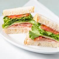 Classic Club Sandwich · Black forest ham, oven gold turkey, bacon, lettuce, tomato and mayo, served on our sourdough...