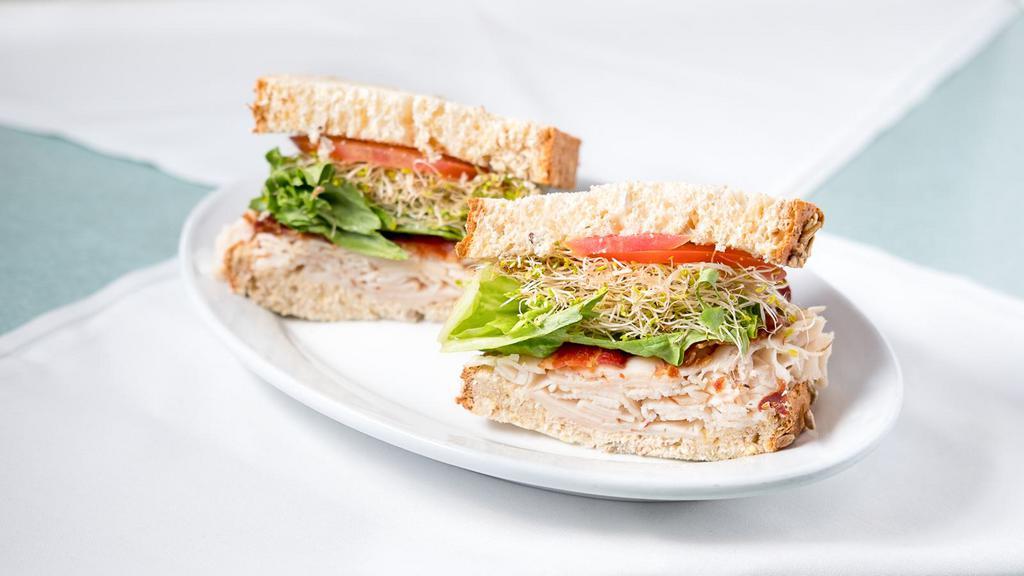 Mediterranean Club Sandwich · Oven gold turkey, bacon, avocado, lettuce, tomato and chipotle mayo served on toasted multigrain bread.