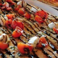 Oven-Fired Bruschetta · Cherry tomatoes, fresh basil, housemade fresh mozzarella, garlic, balsamic syrup.