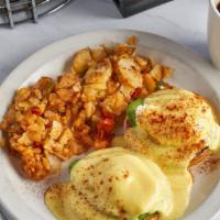 Egg Benedict · House specialty. Poached eggs and homestyle ham or fresh spinach topped with hollandaise sau...