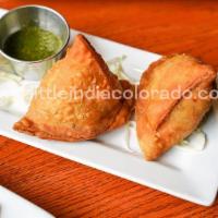 Meat Samosa · Crispy pastry with ground chicken, lamb and spices