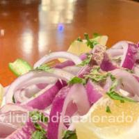 Indian Onion Salad · Sliced onion, green chilly and lemon topped with chat masala