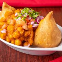 Samosa Chaat · Triangular shape deep fried spiced potato and peas samosa served with yellow peas or chole y...