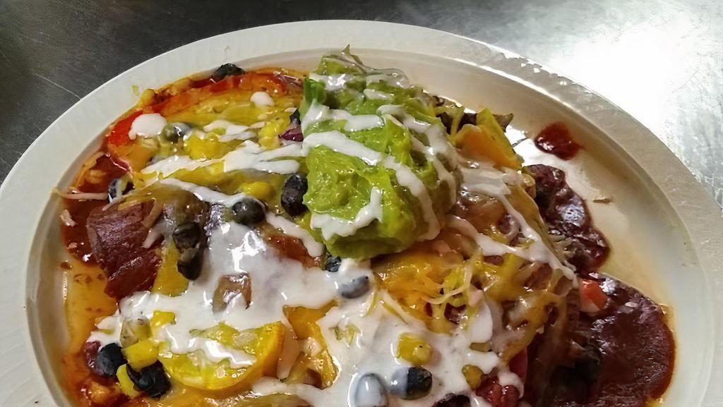 Enchilada · Vegetarian, gluten free. Mild spicy. Roasted vegetables, black beans, corn, cheese, and avocado with blue corn tortillas. Smothered with your choice of red or green chile topped with lime crema. Served with corn tortilla chips and Acre salsa.