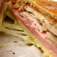 Sandwich Cubano · Roasted pork,  ham, swiss, mustard & pickles pressed on Cuban bread