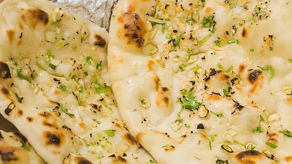 Garlic Naan · Indian flat bread prepared in oven, topped with butter and garlic - 2 pieces
