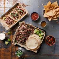 La Gran Fiesta (Served Family Style) - Serves 4 · Enough tacos for everyone; slow-cooked, shredded protein of your choice; fire-roasted pepper...