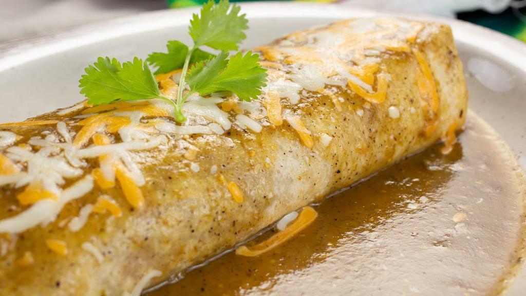 Shredded Chicken El Torito Burrito · Delicious shredded chicken burrito topped with cheese and green chili, served with rice and beans.