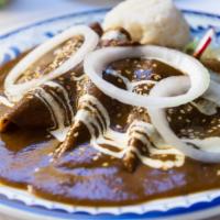 Mole Enchiladas · Delicious shredded chicken topped with sweet and savory mole sauce.