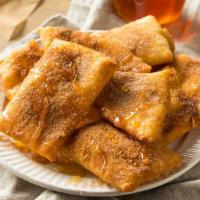 Sopapillas · Delicious puffy fried dough triangles topped with honey & cinnamon sugar, served with vanill...