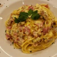 Spaghetti Carbonara · Italian sausage, prosciutto, roasted garlic, Romano Cheese and whole egg sauteed in a cream ...