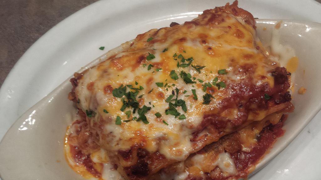 Signature Meat Lasagna · Blend Italian sausage, Italian beef, and salami layered between thick pasta with a blend of cheeses and meat sauce. Served with baked focaccia bread.