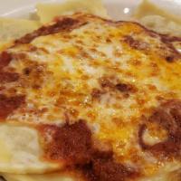 Baked Ravioli · Pockets of pasta stuffed with Italian sausage, beef, garlic, Romano and ricotta cheese toppe...