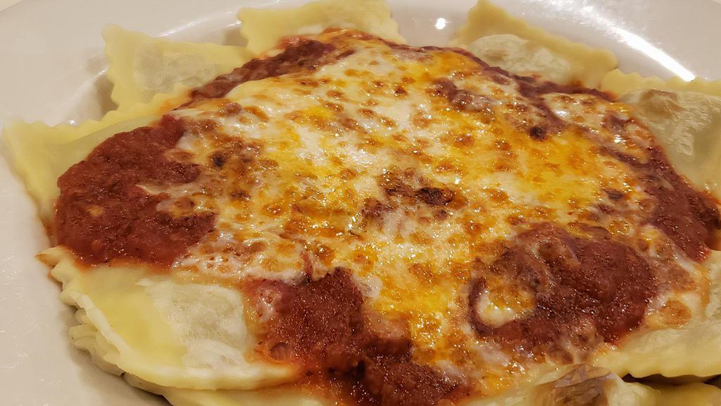 Baked Ravioli · Pockets of pasta stuffed with Italian sausage, beef, garlic, Romano and ricotta cheese topped with Ernesto's meat sauce and provolone cheese, then broiled.