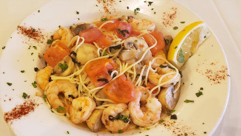 Shrimp Scampi · Shrimp and mushrooms sauteed in roasted garlic and tossed with a white wine sauce basil and Roma tomatoes over angel hair pasta.