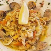 Clam Linquini · Steamed and chopped clams seasoned with butter, roasted garlic, and lemon. Served over angel...