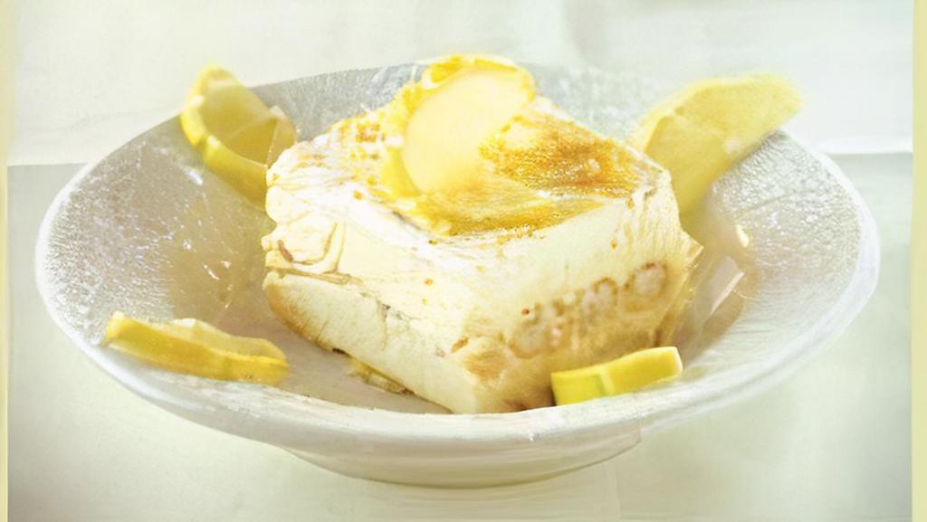 Lemon Tiramisu · Lady fingers basted in Limoncello with whipped mascarpone filling and garnished with lemon zest.