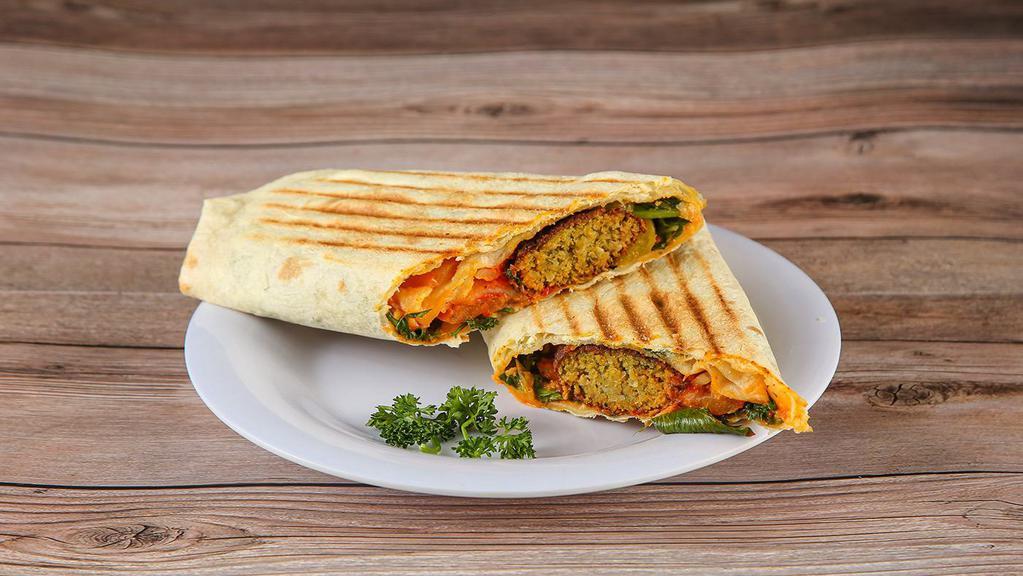 Falafel Wrap · A vegetarian dish blend of fresh garbanzo beans, vegetables and seasonings, deep-fried and topped with Seasonal Mix Lettuce, Tomatoes, Onions, Mediterranean Pickles, and choice of sauce. Wrapped up in flour.
