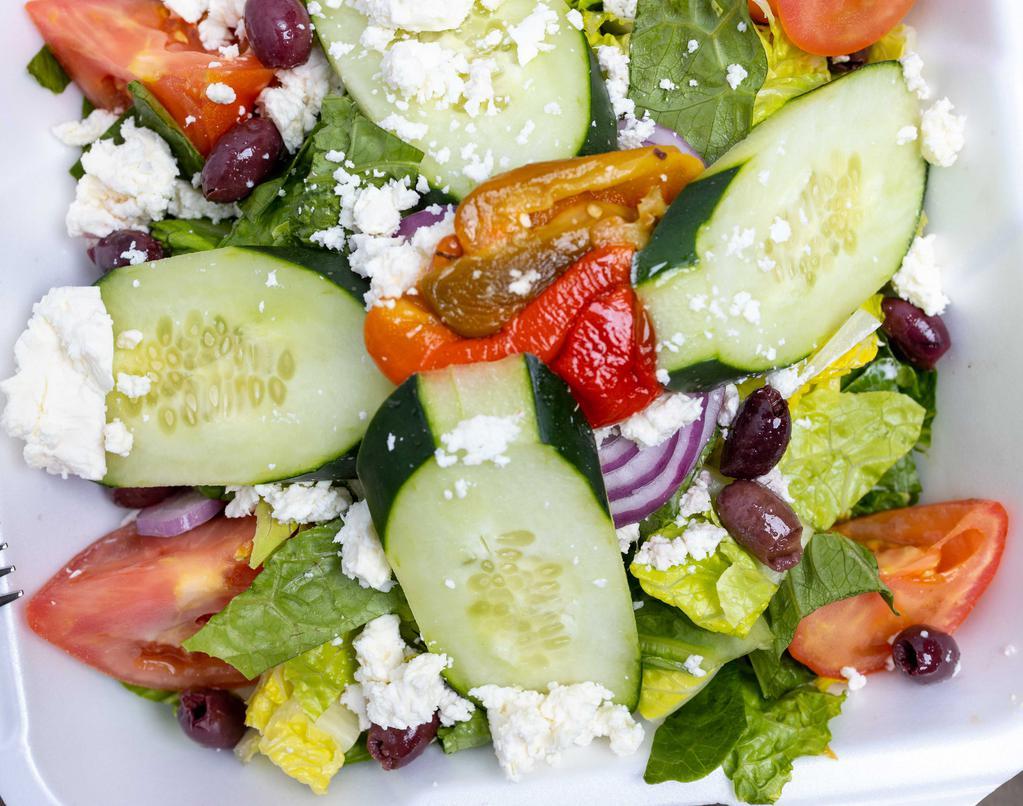 The Greek · Romaine lettuce, feta cheese, roasted peppers, Bermuda onions, tomatoes, cucumbers, and Kalamata olives.