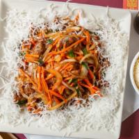 Mongolian Beef · Sliced beef, carrots, yellow, and green onions sautéed in brown sauce spread on a bed of fri...