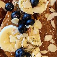 Almond Banana Berry Toast · Toasted Sourdough, Almond Butter, Banana, Blueberries, Almond Slices, Hemp Seeds.