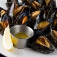 Steamed Prince Edward Island Mussels · White wine, garlic, tomatoes and beurre blanc.