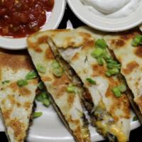 Loaded Quesadilla · Seasoned ground beef, shredded chicken or smoked pulled pork in a 13'' flour tortilla stuffe...