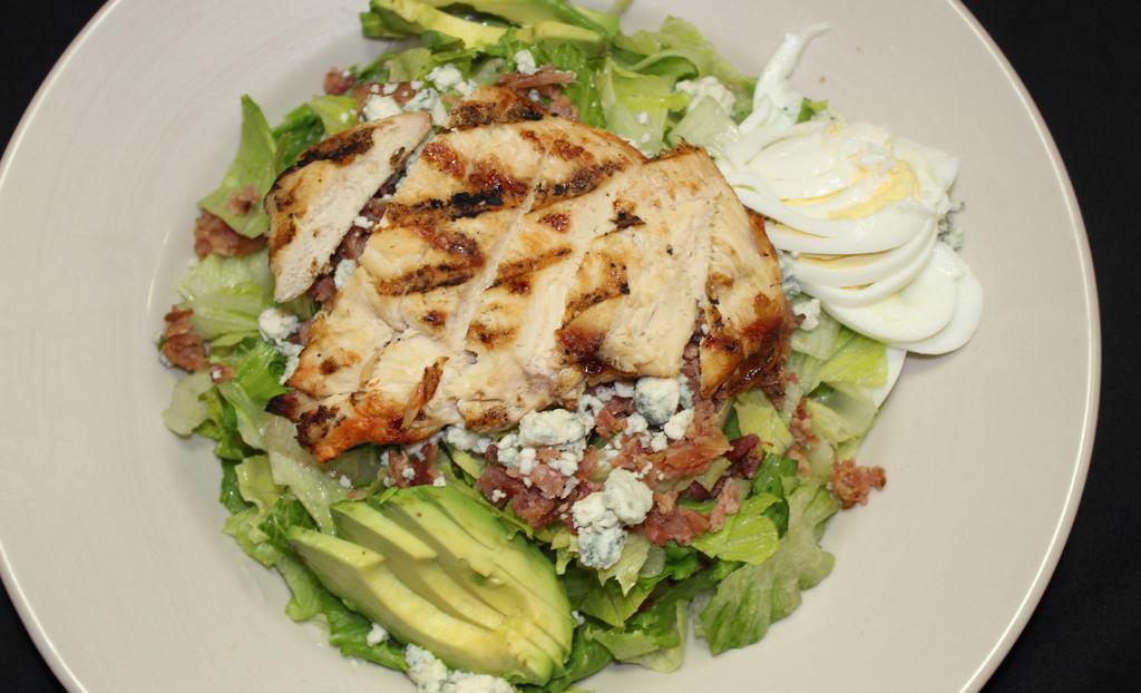 Cobb Salad · Grilled chicken, bleu cheese crumbles, red onion, avocado, egg, bacon and tomato. Served with a side of bleu cheese dressing.