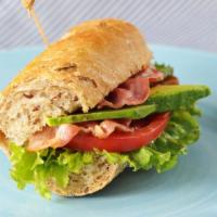 Turkey Avocado Sandwich · Delicious sandwich made with fresh baguette, turkey slices, bacon, avocado, pesto mayonette,...