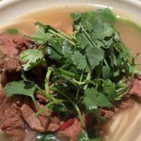 Beef Noodle Soup · Includes spinach, cilantro, green onion, and pickle.
