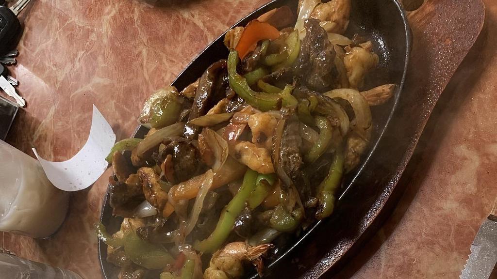 Fajitas Mixtas · steak, shrimps, and chicken, sauteed with bell peppers, onions. served with beans and rice, sour cream guacamole, corn or flour tortillas.