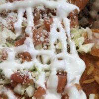 Enchiladas Rancheras · 2 enchiladas bathed in adobo and filled with cheese,choice of meat, garnished with cabbage, ...