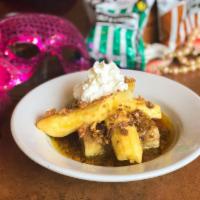 Bananas Foster Bread Pudding · Classic bread pudding topped with sauteed bananas in a rich caramel and spiced rum sauce, ca...