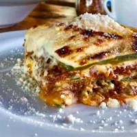 Lasagna Alla Bolognese · Traditional bolognese sauce and homemade bechamel layered in egg dough pasta, baked in the o...