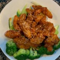 Sesame Chicken · Hot and spicy. Crispy chicken nuggets tossed in sweet and spicy sesame sauce. Served on a be...