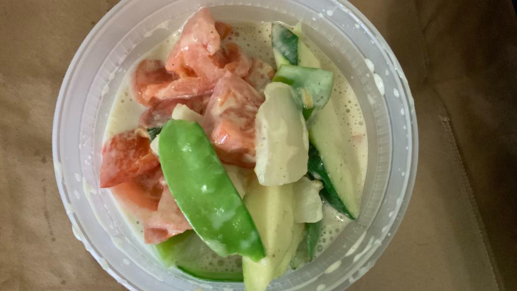 Green Curry · Spicy green curry with snow peas, tomato, red, and green peppers, onions, and sweet basil.