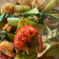 Thai Basil Seafood · Hot and spicy. Jumbo shrimp, sea scallops, lobster tail, and white fish sauteed with leeks, ...