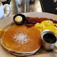 The Pancakes Combo · Two large pancakes served with two eggs any style, biscuits, and choice of bacon, sausage, o...