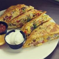Blackened Chicken Quesadilla · Grilled tomato basil tortilla stuffed with 3 cheese blackened chicken onions, tomatoes and j...