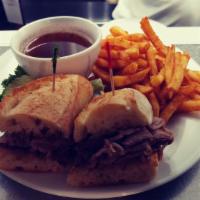 Seasoned Prime Rib Dip · Seasoned prime rib sliced thin and piled high on a toasted French baguette with au-jus.